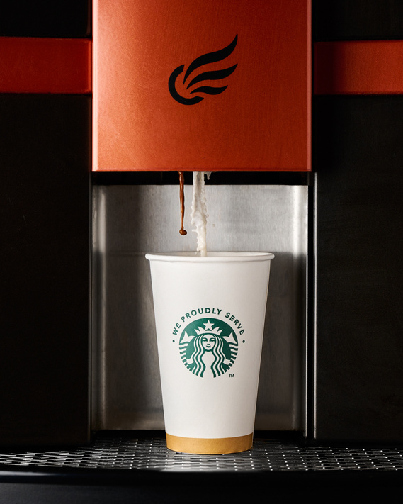 Milk and espresso being automatically dispensed into Starbuck's Cup from automatic latte machine. Image by Megan Morello Commercial food photographer and lifestyle photographer in San Diego, Southern California.