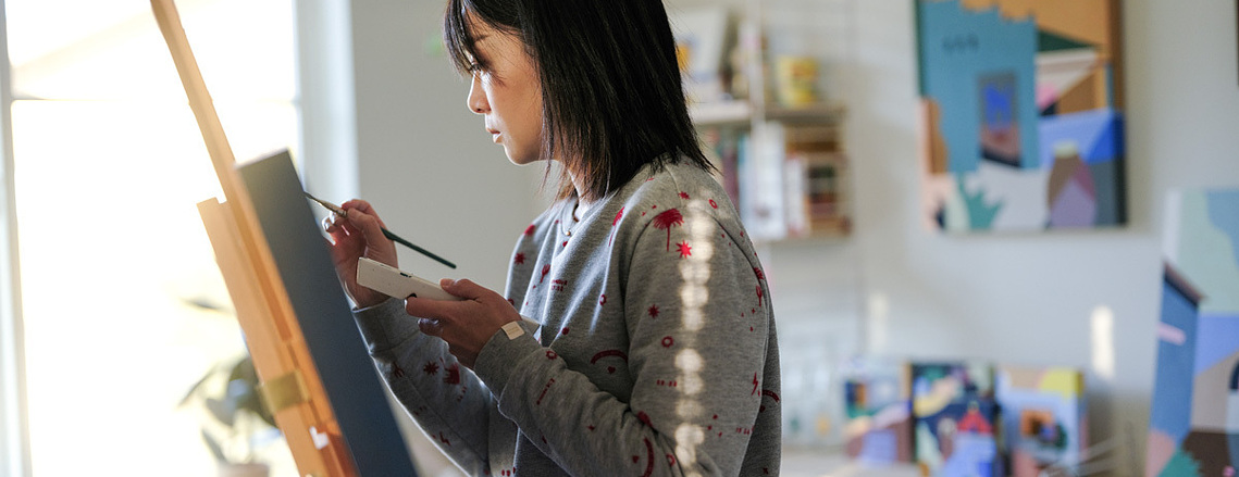 Artist Annie Chen working on her painting in her home studio in Squamish.