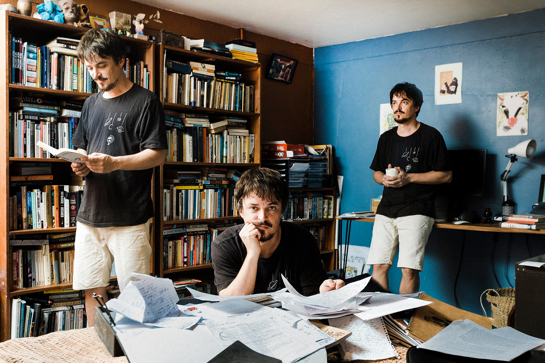 A multiple exposure photograph of a male writer in his office.