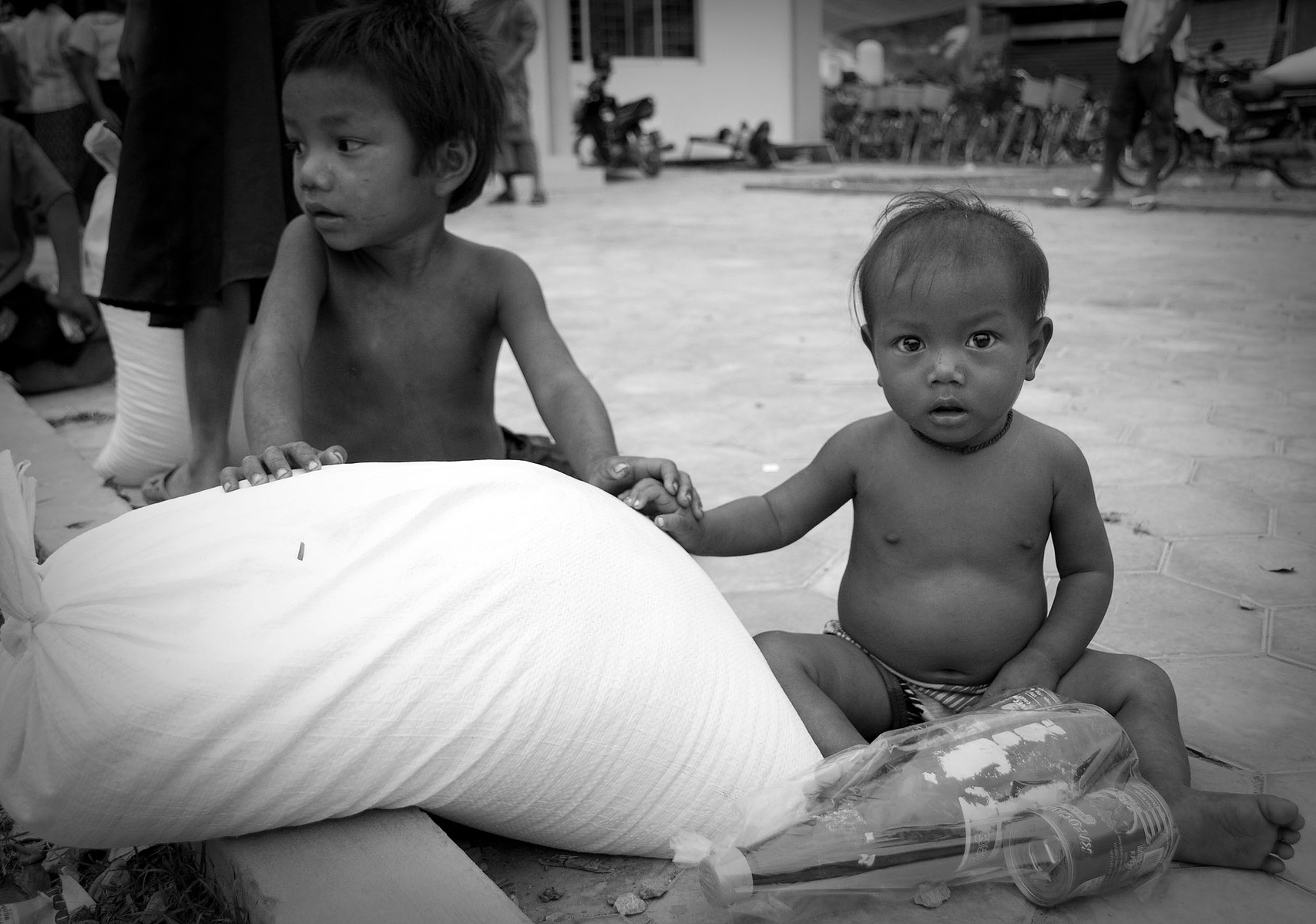 Article 6: "...every child has the inherent right to life". Children receive a bag of rice and sauce, Cambodia.