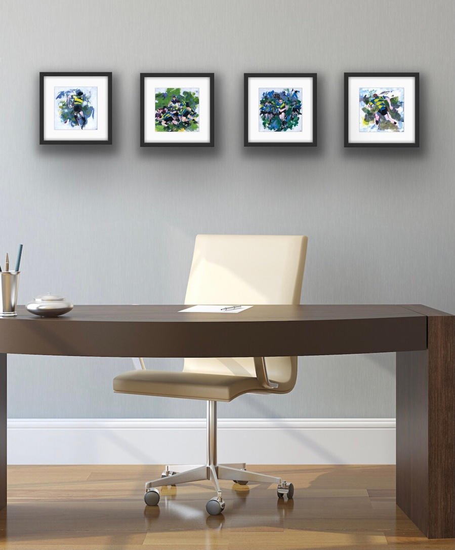 An office with four limited edition prints hanging in a row framed on the wall.