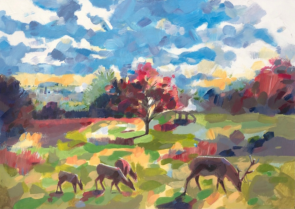 A group of deer and stag grazing in a field of autumn colours set against cloudy blue skies. 