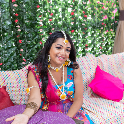 bride poses with mehndi and henna during mehndi night