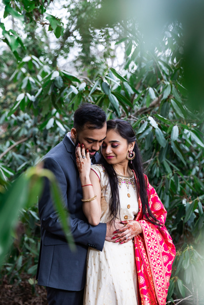 couple engagement session with greenery background