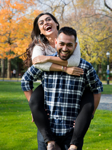 fall couple's session where man is giving a piggyback ride