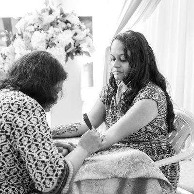 black and white photo of bride getting henna 