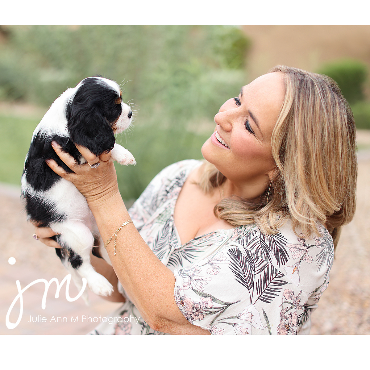 Dog breeder with owner.  Black and white puppy.