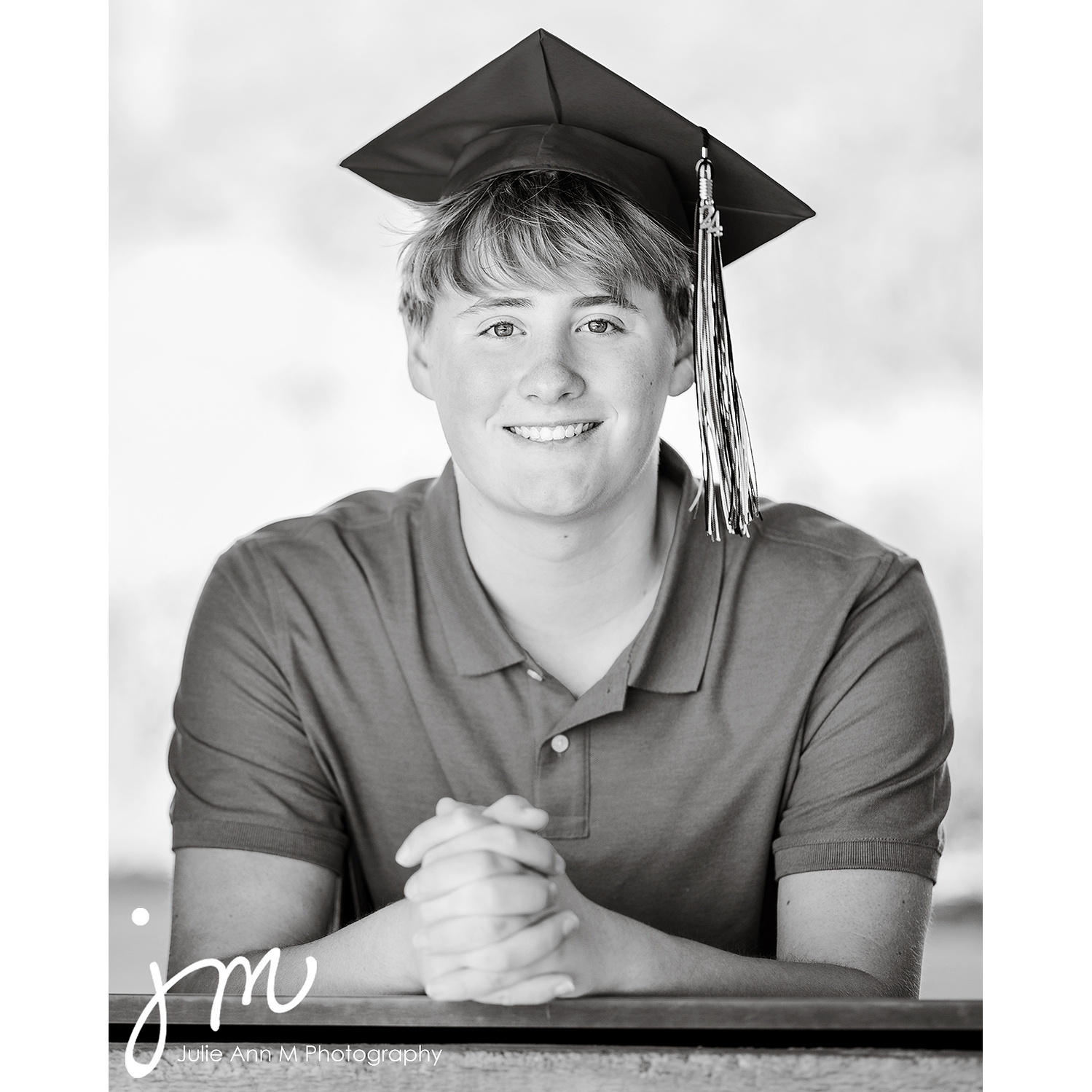 Senior in graduation cap, photograph is black and white