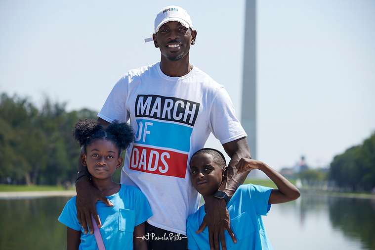Sean Williams, The Dad Gang founder, takes a moment after the march to pose for a picture with 2 of his 3 children, Cameron (left) and Ethan (right).  Williams says it is amazing being a dad 24/7.
