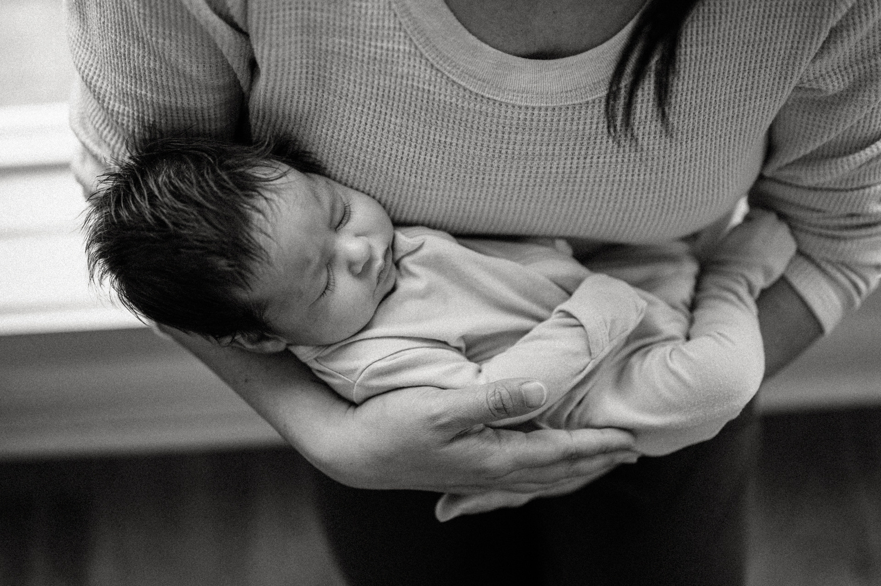 A mother holds her newborn during an arlington ma newborn photography session