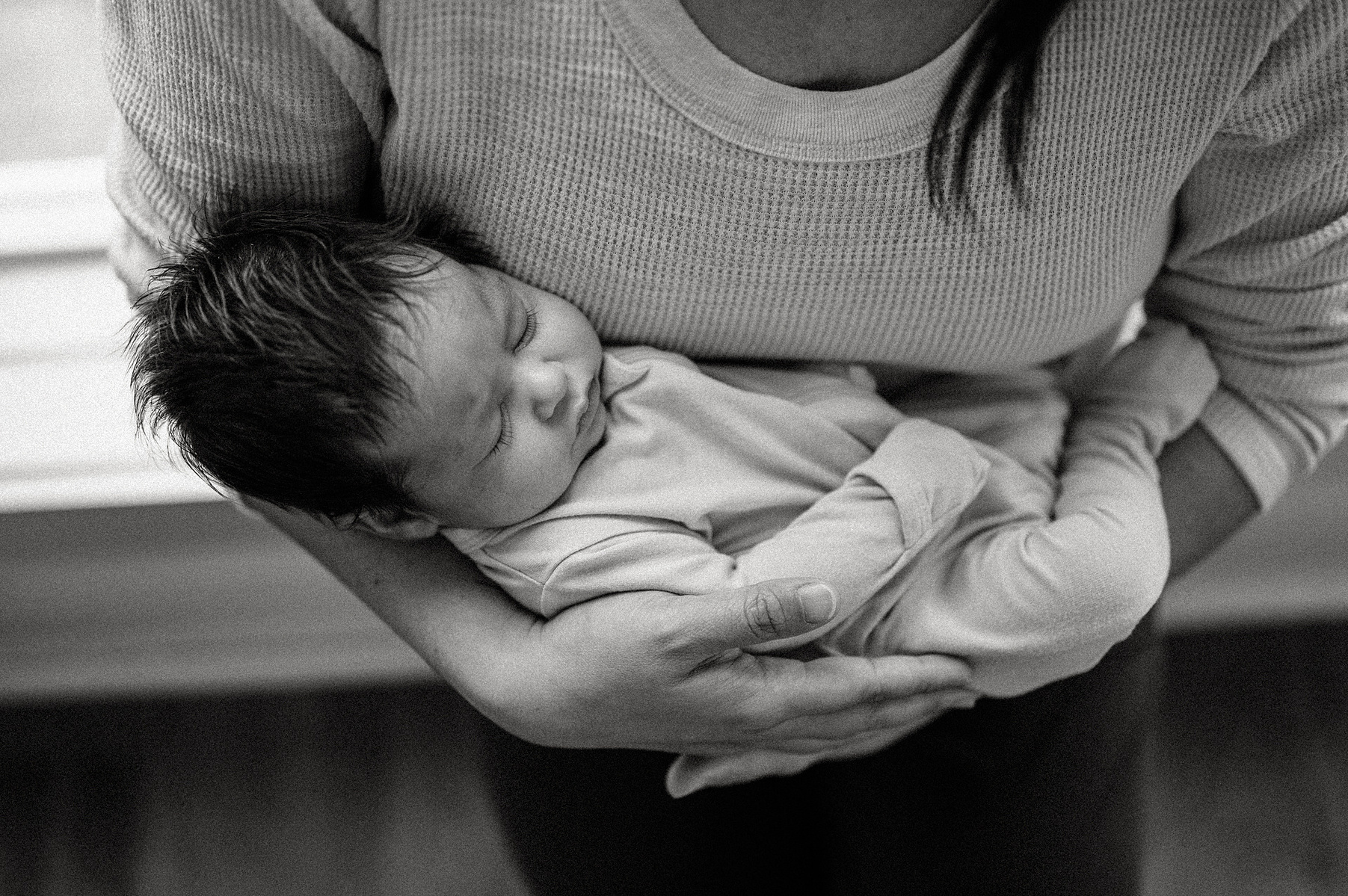 A mother holds her newborn during an arlington ma newborn photography session