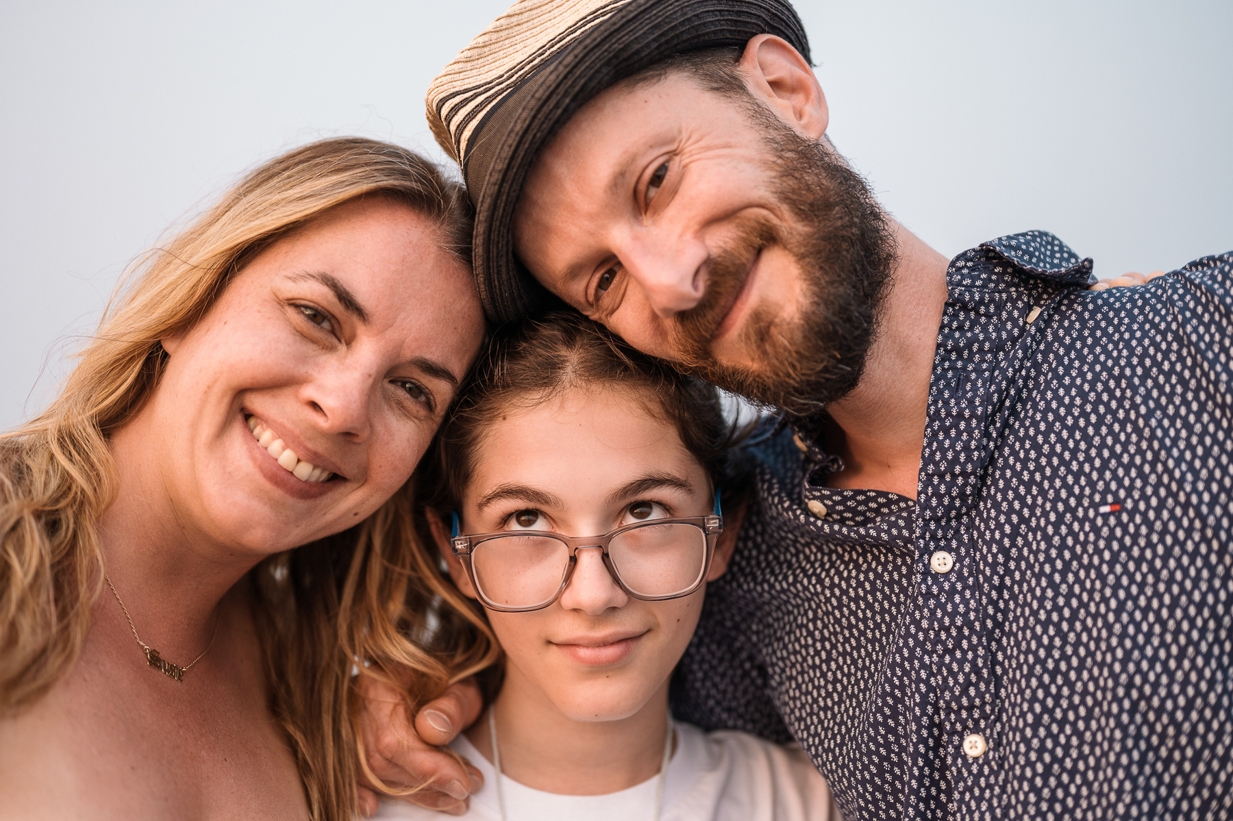 A family rests their heads together and smiles for the camera at their Hull family photography session by Korri Leigh Photography