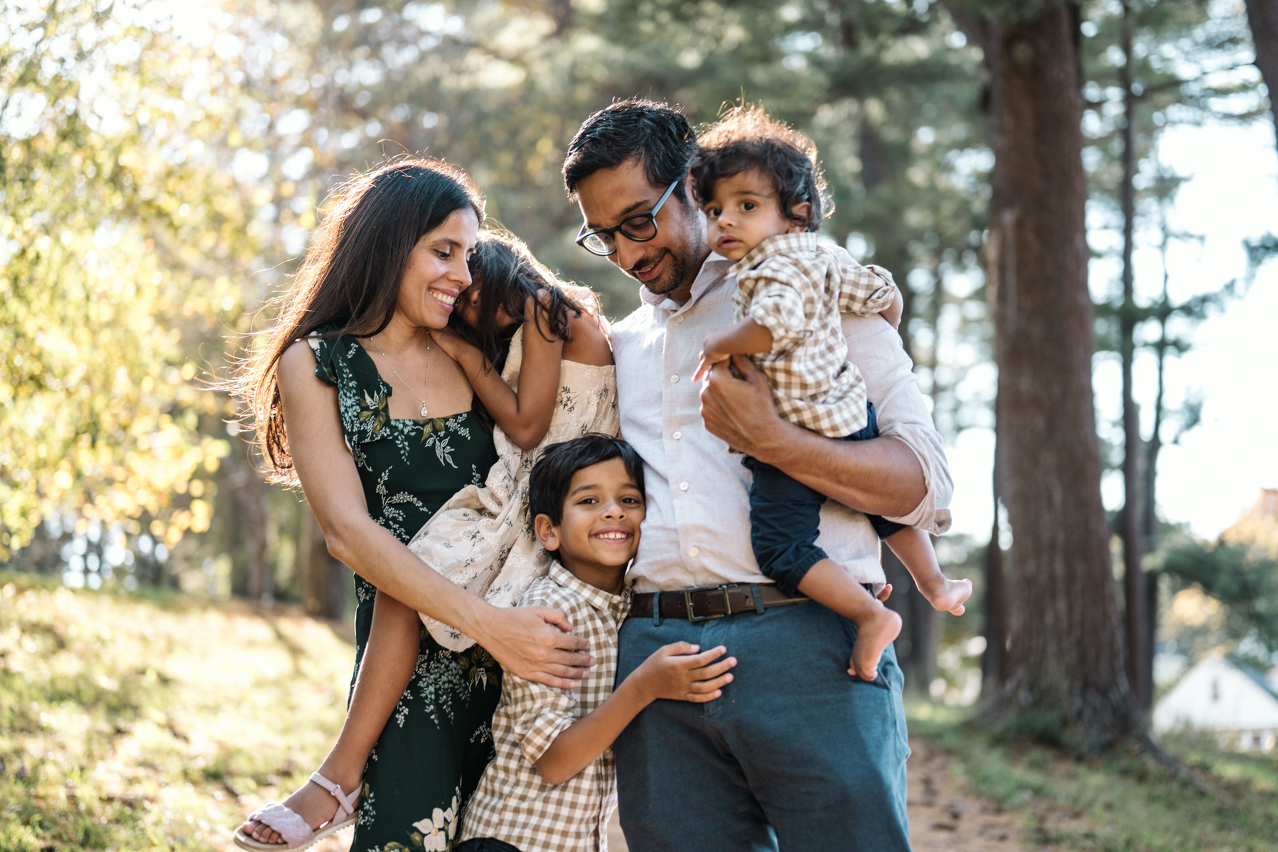 A family poses in arnold arboretum during their boston family photography session by west roxbury family photographer korri leigh crowley
