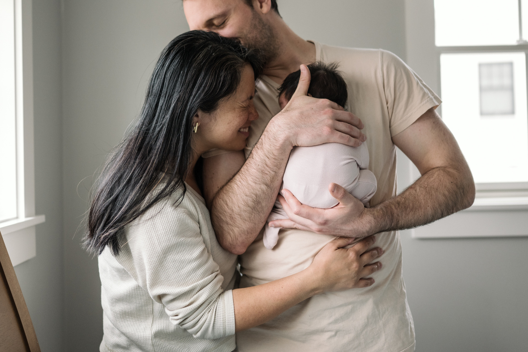 Mom and Dad snuggle a baby during a Boston ma newborn photography session