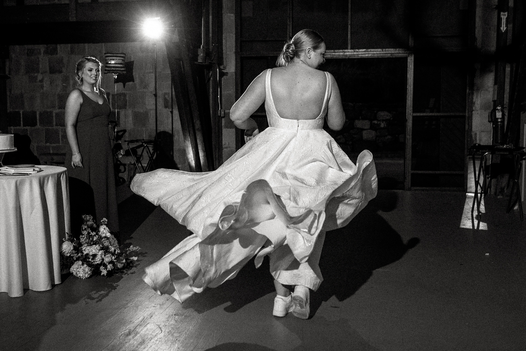As a bride twirls her dress flies out behind her in waves of white fabric at her Ipswich MA wedding