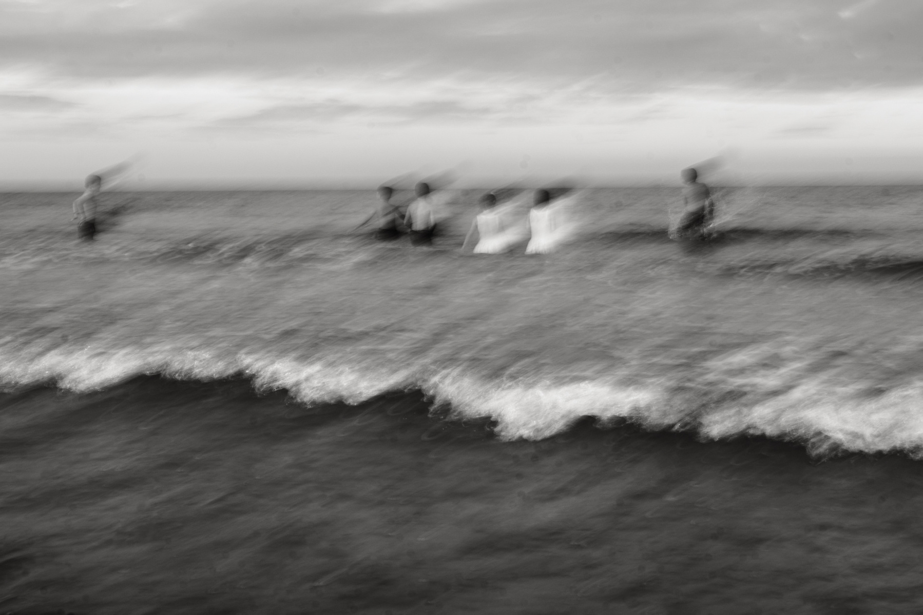 An artsy photo of kids playing in the water at Nantasket beach during their summer family photography session