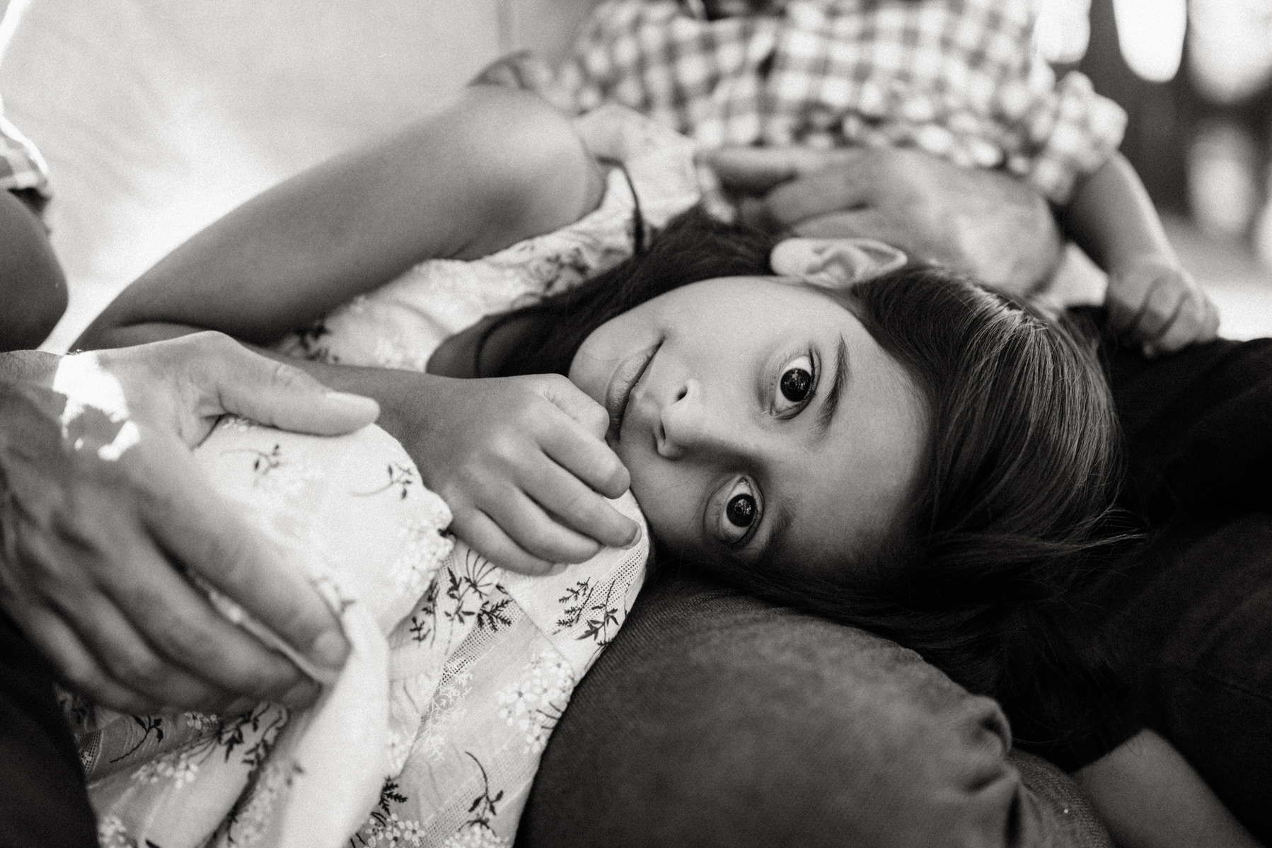 A young girl gazes at the camera during a boston family photography session by west roxbury photographer korri leigh crowley