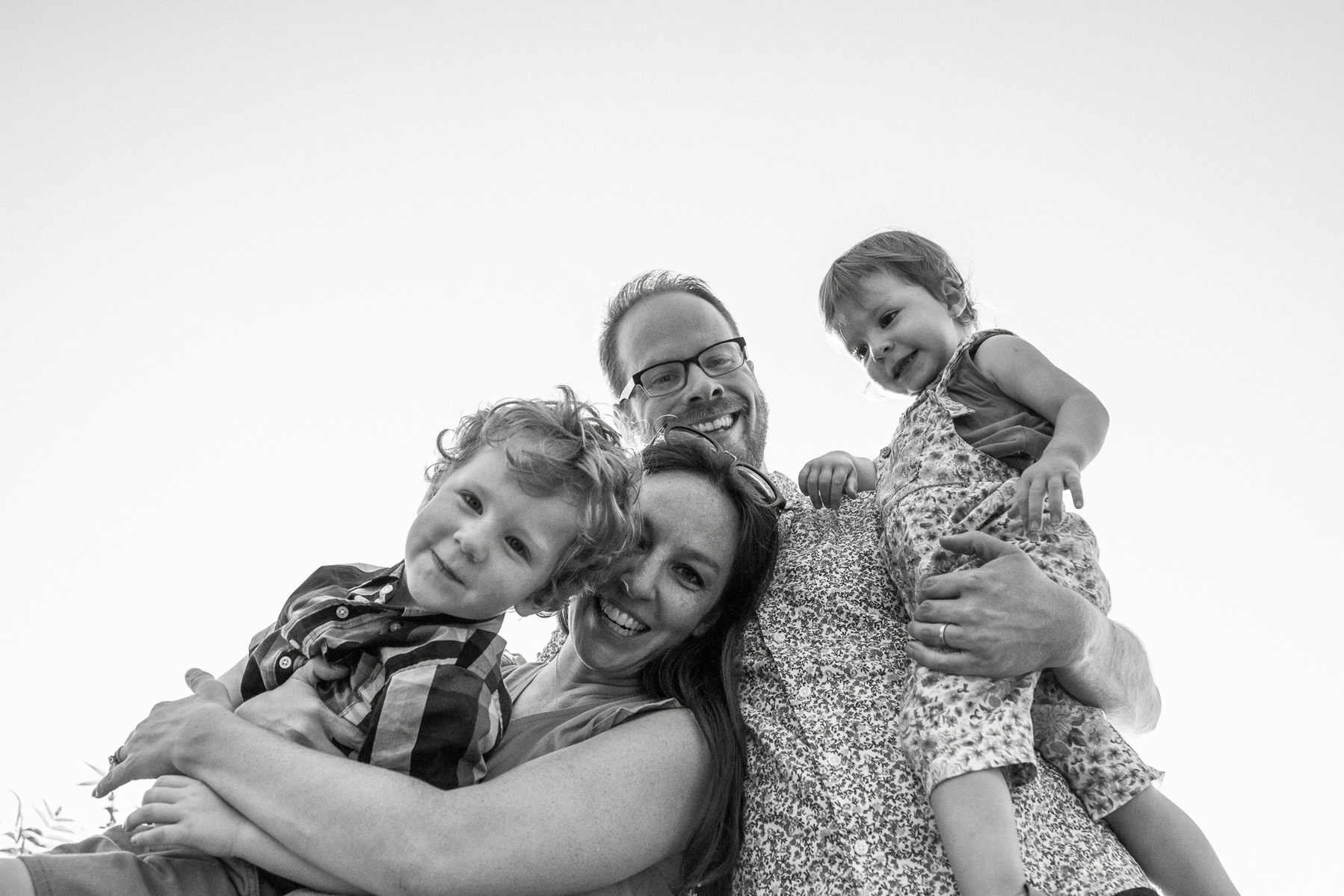 Parents playfully pose with their kids during a family photo session at Fisher Hill Reservoir Park in Chestnut Hill by Brookline family photographer Korri Leigh Photography