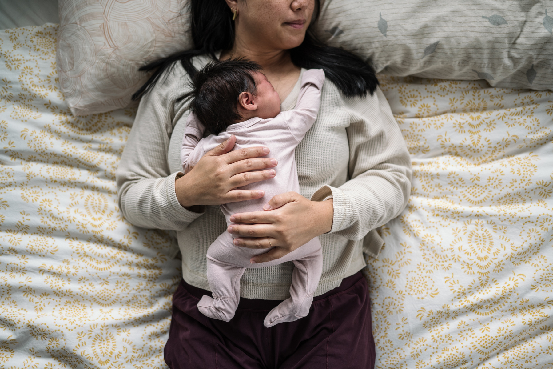 A newborn laying on her mother's chest during an arlington newborn photography session