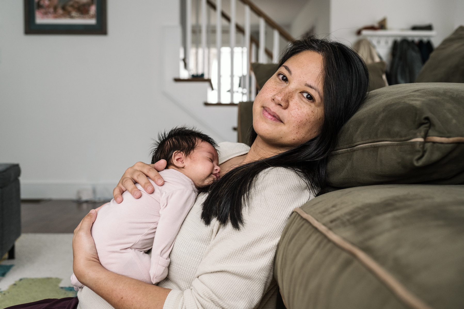 A mother holds her newborn during an arlington ma newborn photography session
