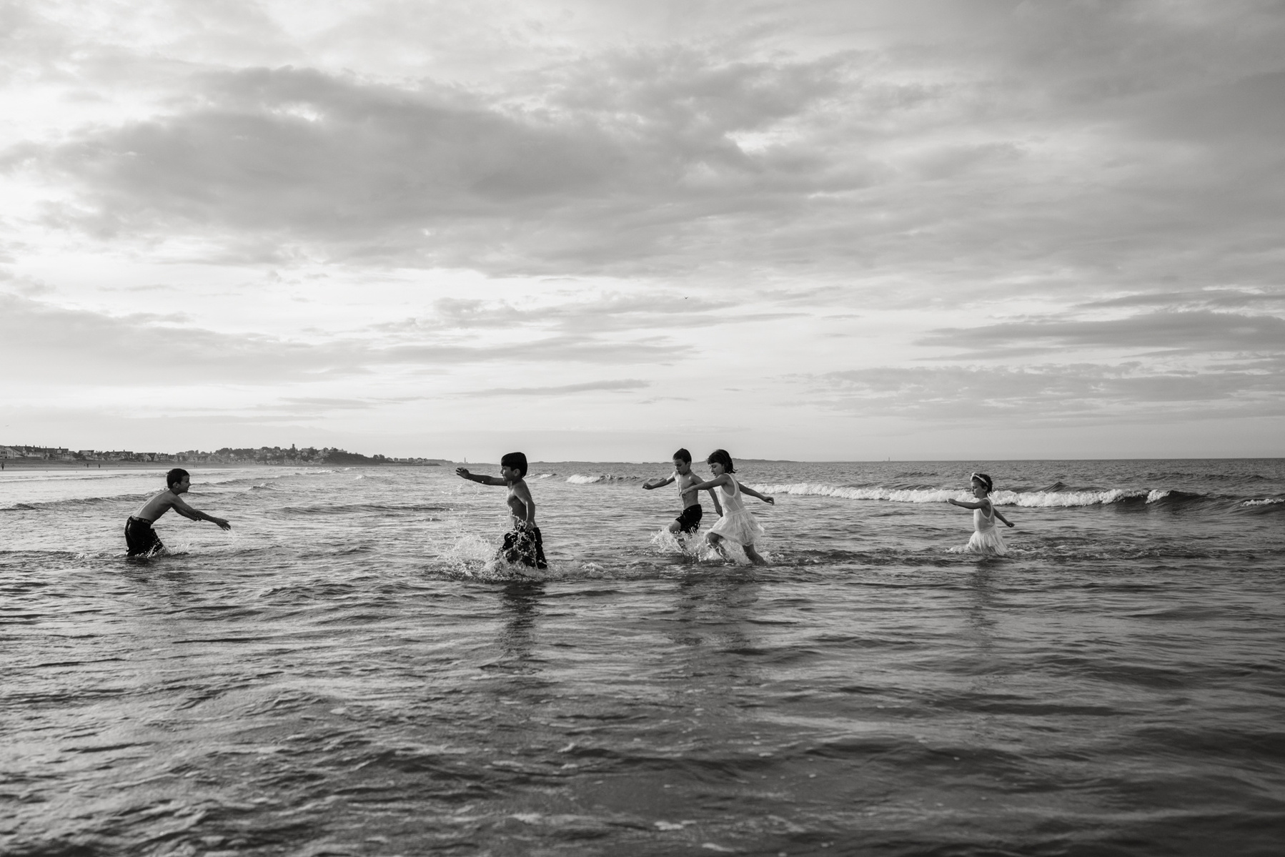 Kids playing in the water at Nantasket beach during their summer family photography session by West Roxbury family photographer Korri Leigh Crowley