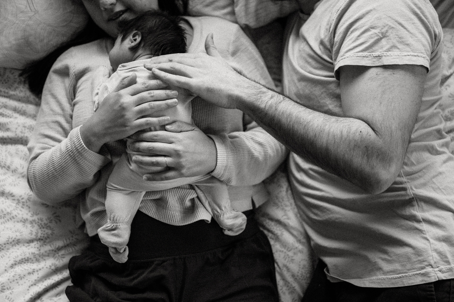 Mom and Dad's hands on a newborn  during an arlington ma newborn photography session