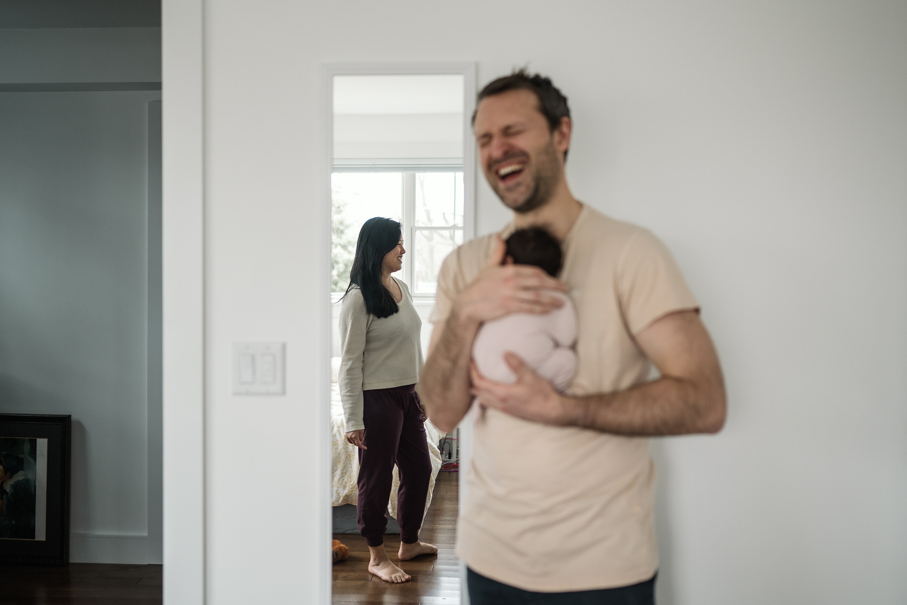 Dad laughs during an arlington ma newborn photography session