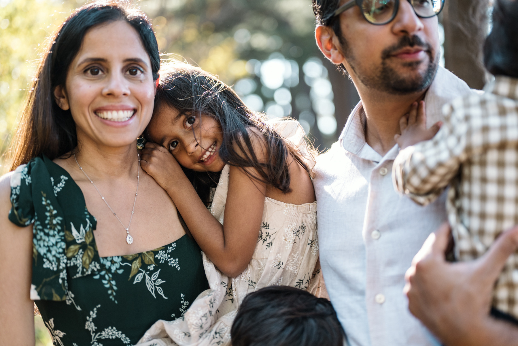A young girl snuggles with mom in the arnold arboretum during their boston family photography session by west roxbury family photographer korri leigh crowley