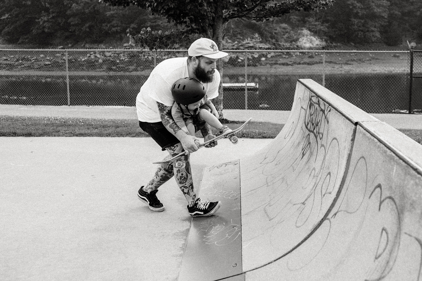 A young boy rides a pink skateboard during a family photo shoot at Innocenti skatepark in Beverly MA