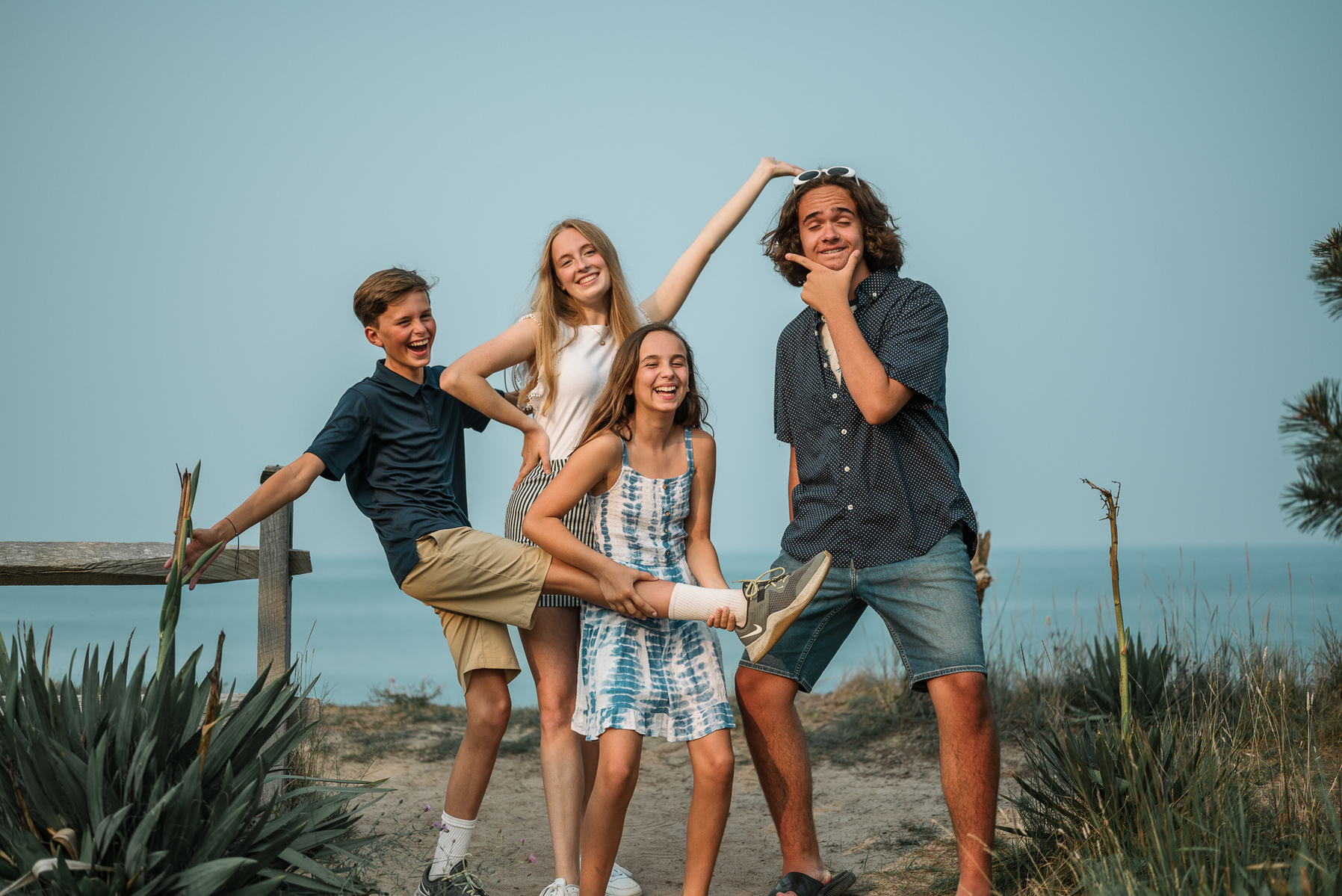 A group of cousins do silly poses at Nauset Lighthouse in Eastham on Cape Cod in Massachusetts