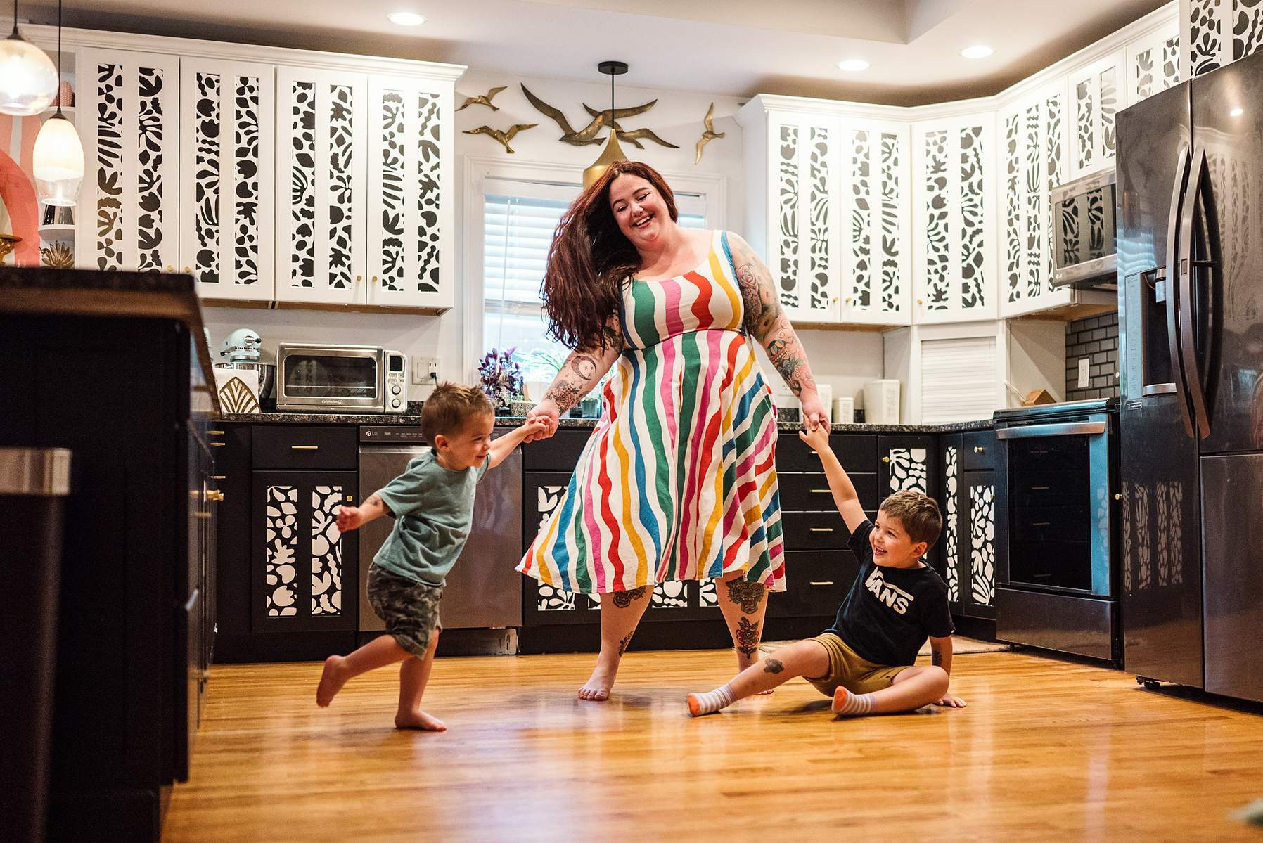A Mom spins and dances with her children during their in home family photography session in Boston