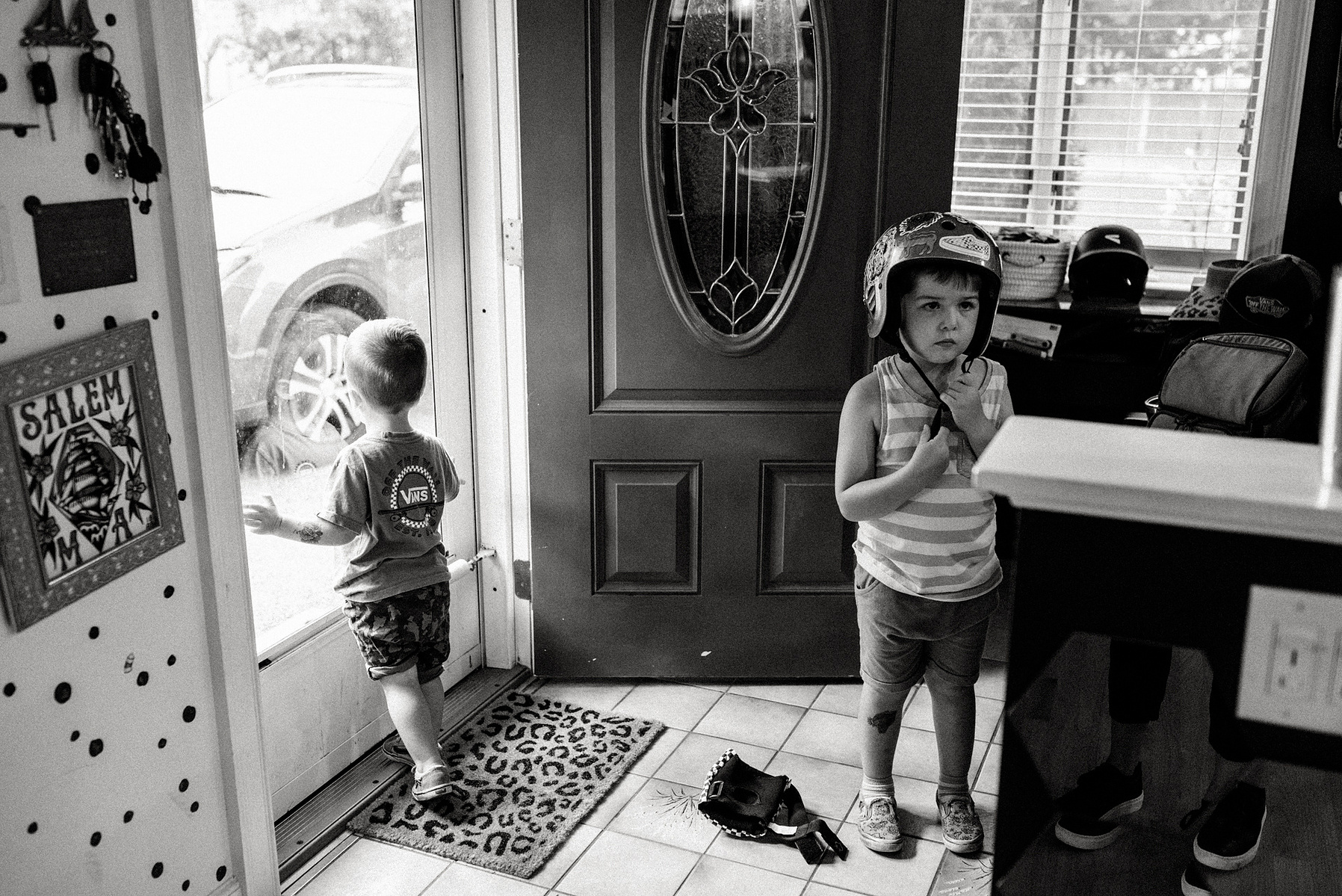 Two young boys get ready to go out and ride bikes during their salem family photo session