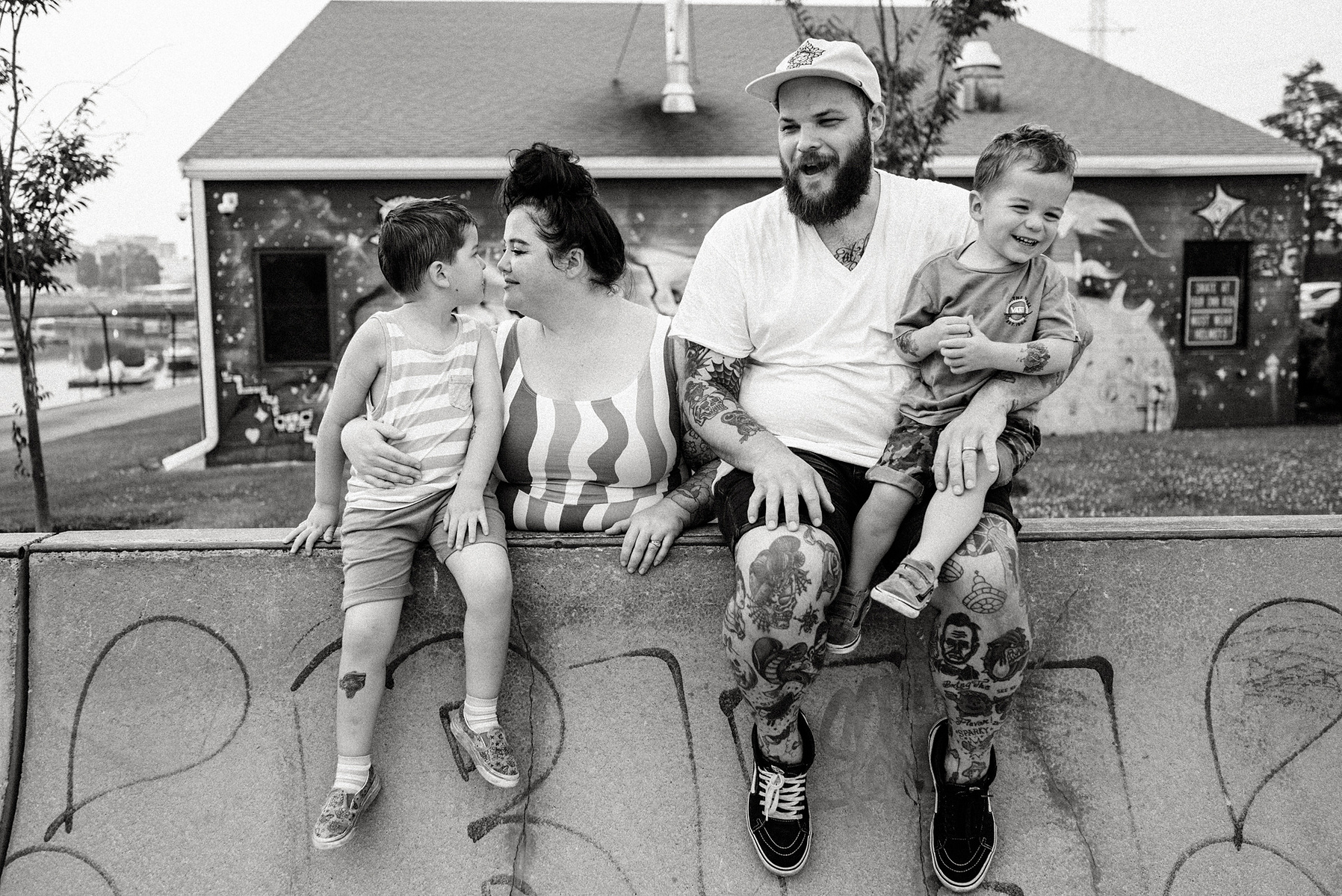 a family poses and smiles at Innocenti skatepark during their beverly family photo shoot