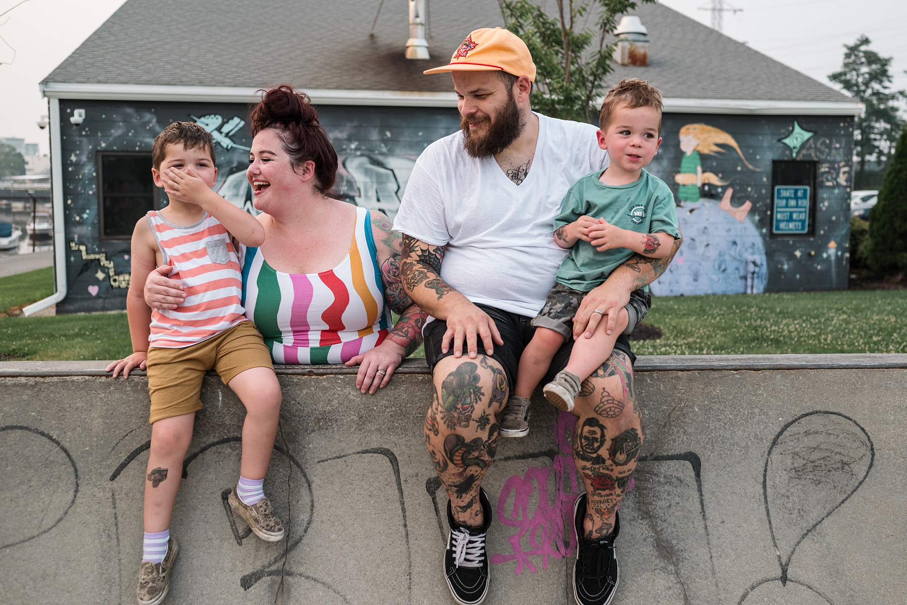 a family poses and smiles at Innocenti skatepark during their beverly family photo shoot