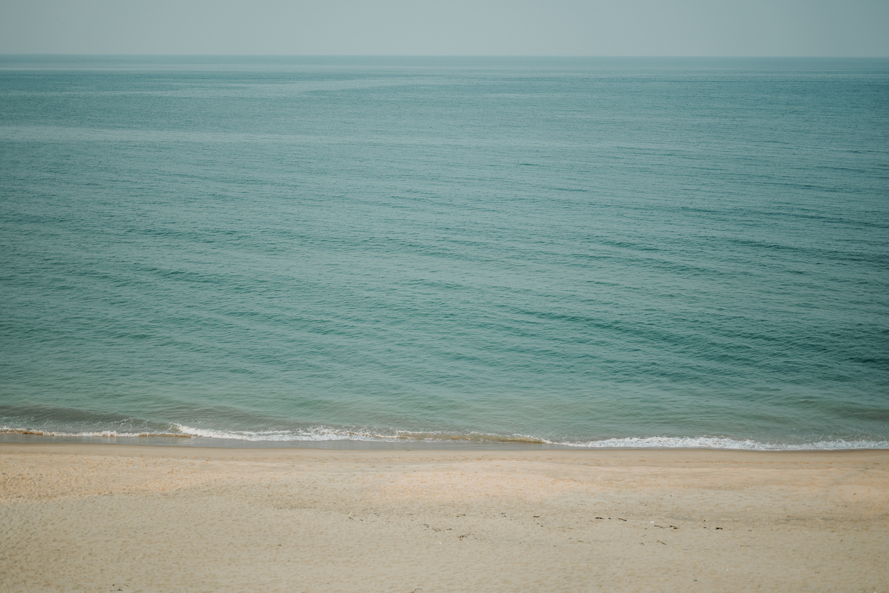 The jade colored Atlantic Ocean as seen from above Constitution Beach on Cape Cod
