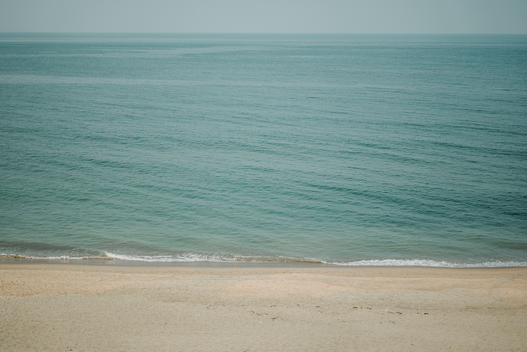 The jade colored Atlantic Ocean as seen from above Constitution Beach on Cape Cod