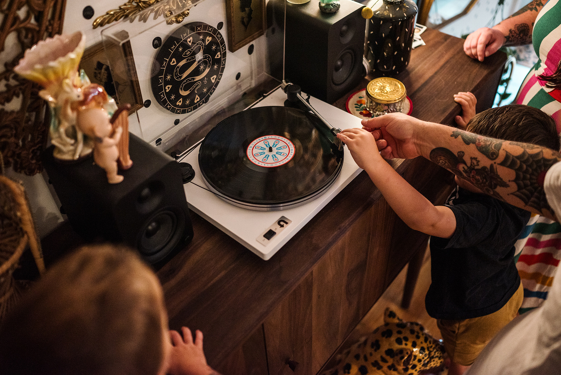 A family listens to records in their maximalist designed Salem MA home captured by boston family photographer Korri Leigh photography