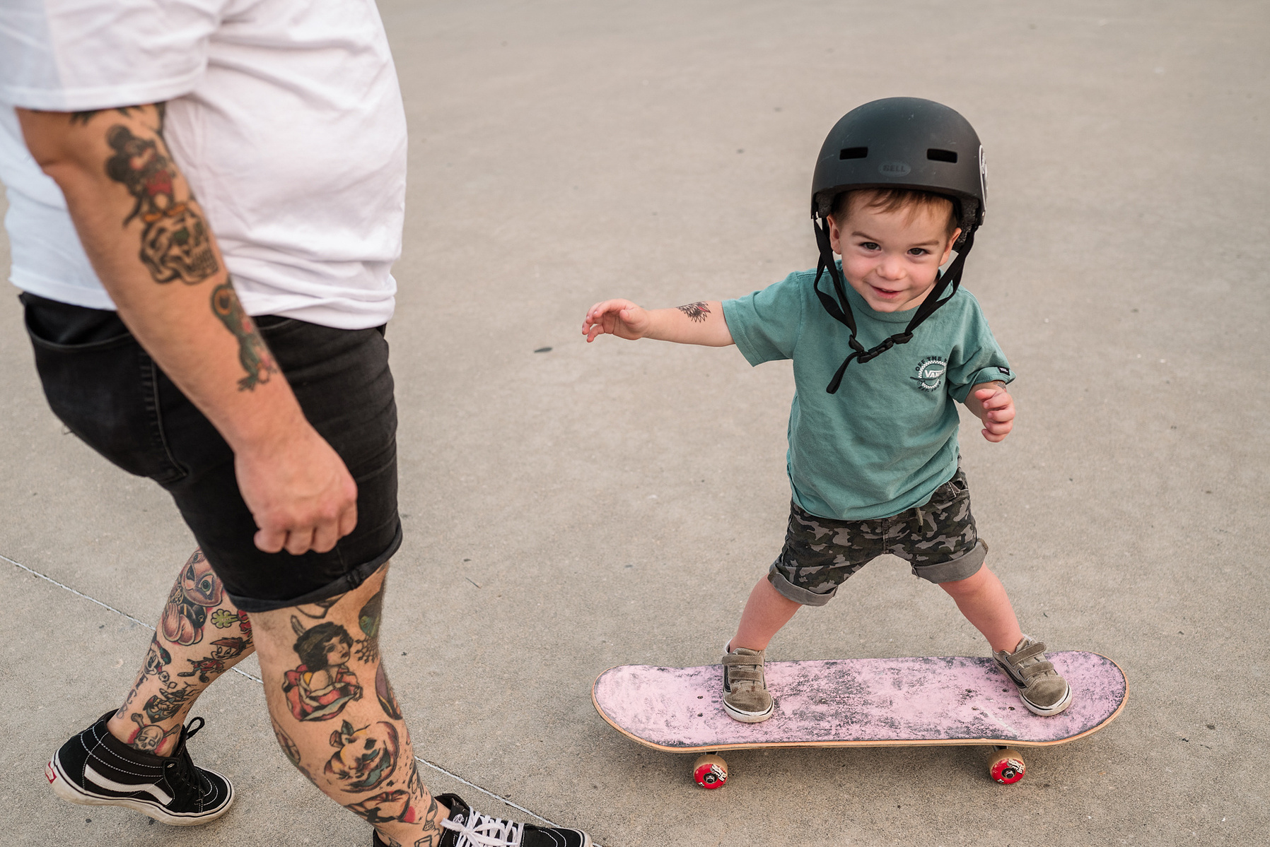 A young boy rides a pink skateboard during a family photo shoot at Innocenti skatepark in Beverly MA