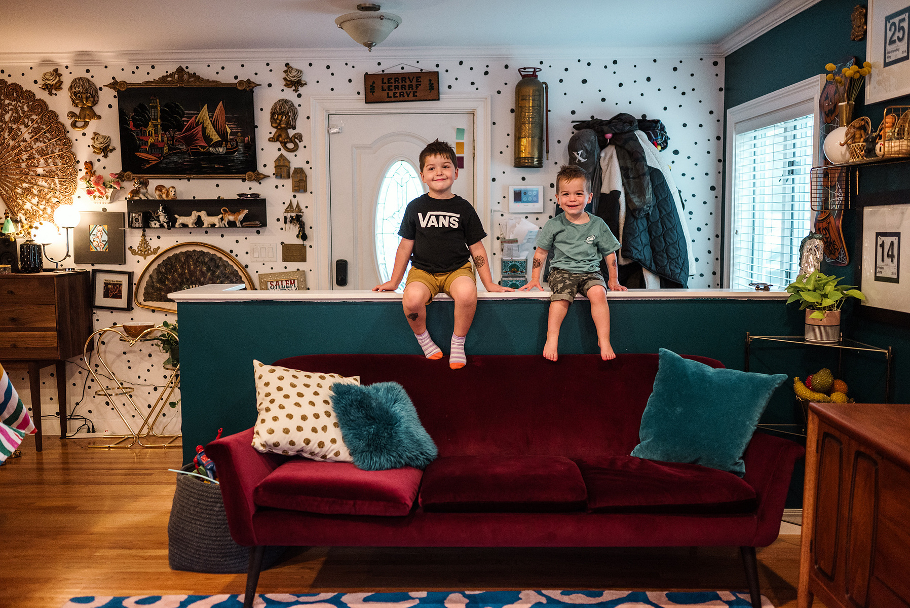 two young boys sit and smile in their maximalist designed salem massachusetts home