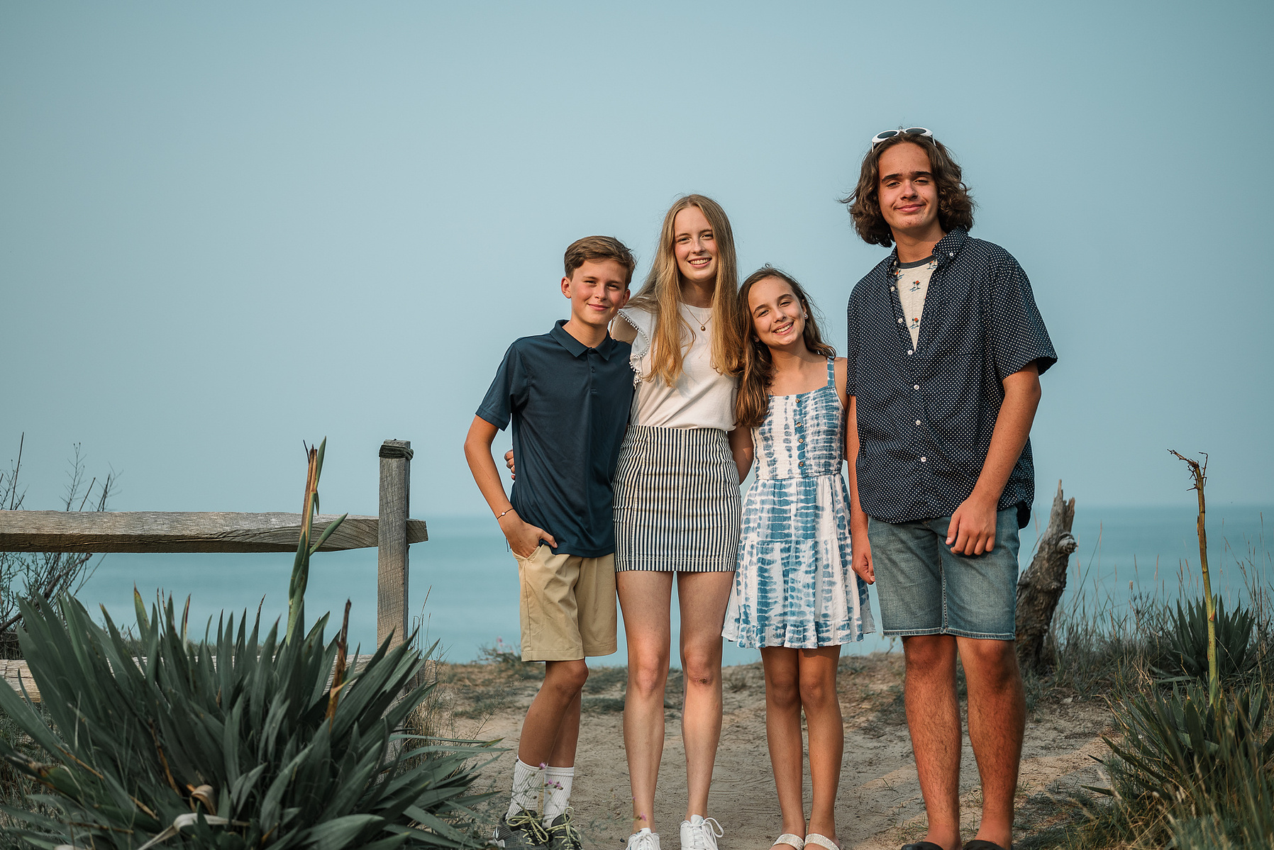 A group of cousins pose at Nauset Lighthouse in Eastham on Cape Cod in Massachusetts