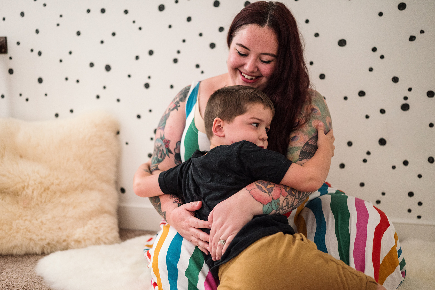 A young boy hugs his Mama during their  in-home family photography session in Salem, MA