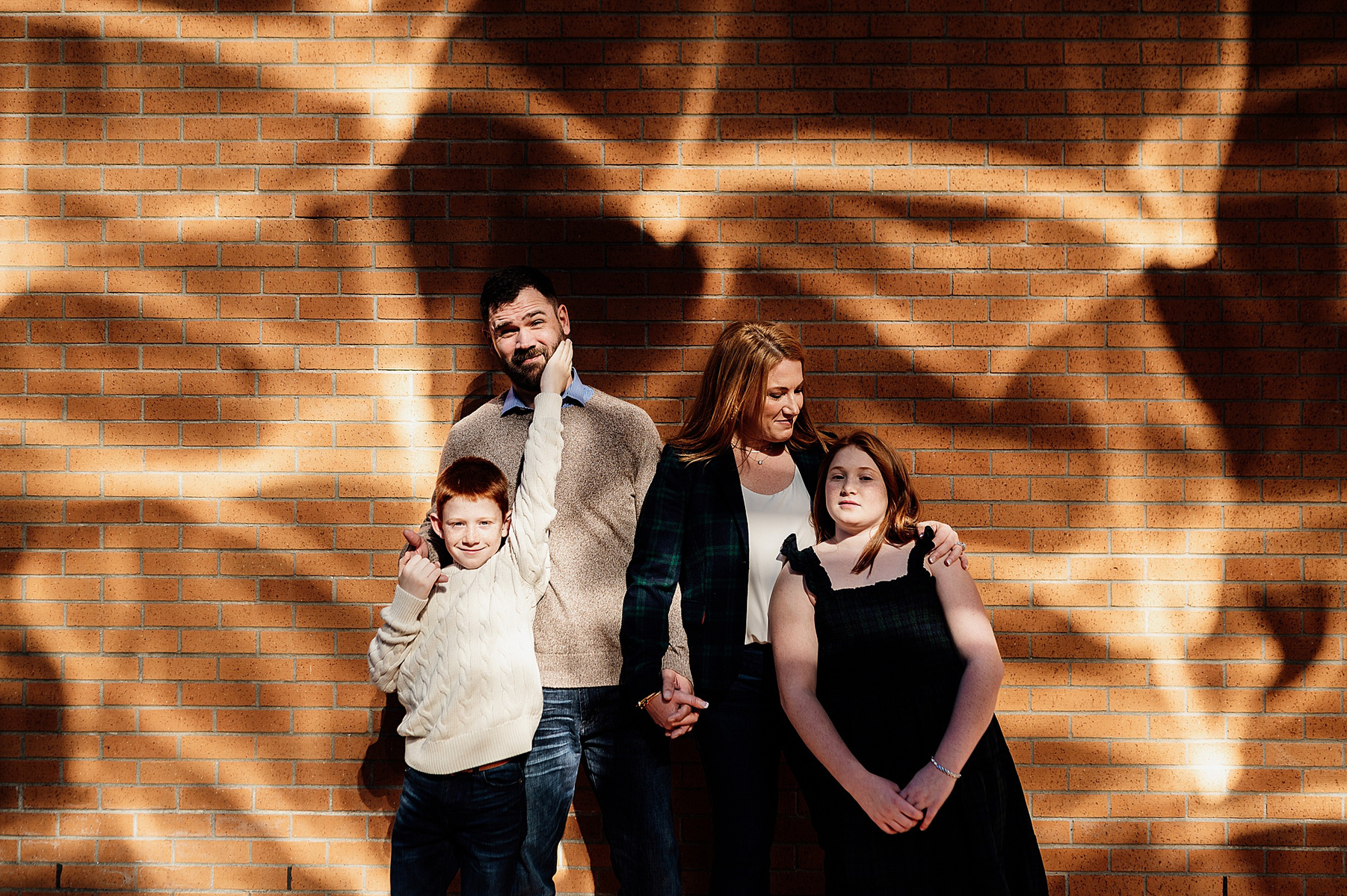 a family posing in front of a patterned wall on the MIT campus by boston family photographer korri leigh photography