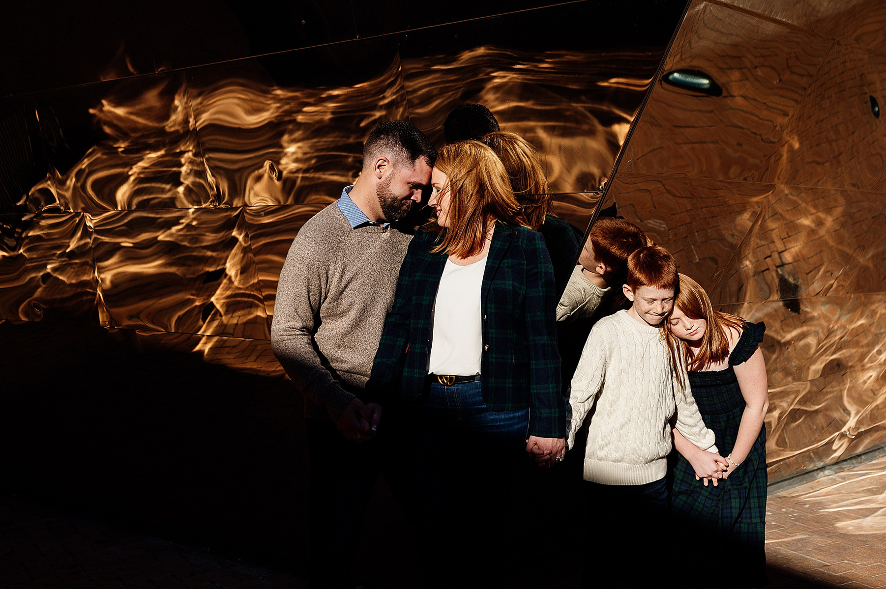 a family posing in front of a patterned wall on the MIT campus by boston family photographer korri leigh photography