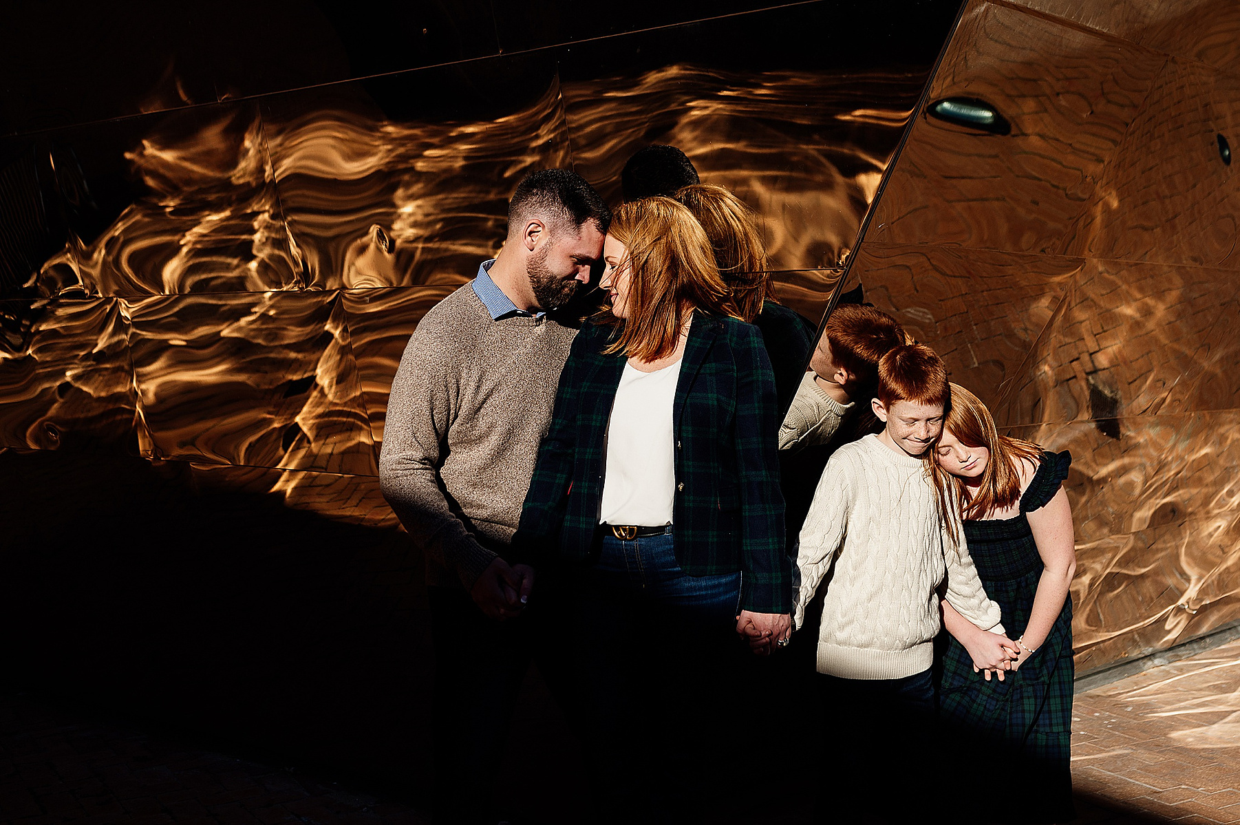 a family posing in front of a patterned wall on the MIT campus by boston family photographer korri leigh photography