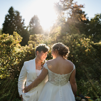 LGBTQ brides pose in golden sunlight at their Long Hill wedding