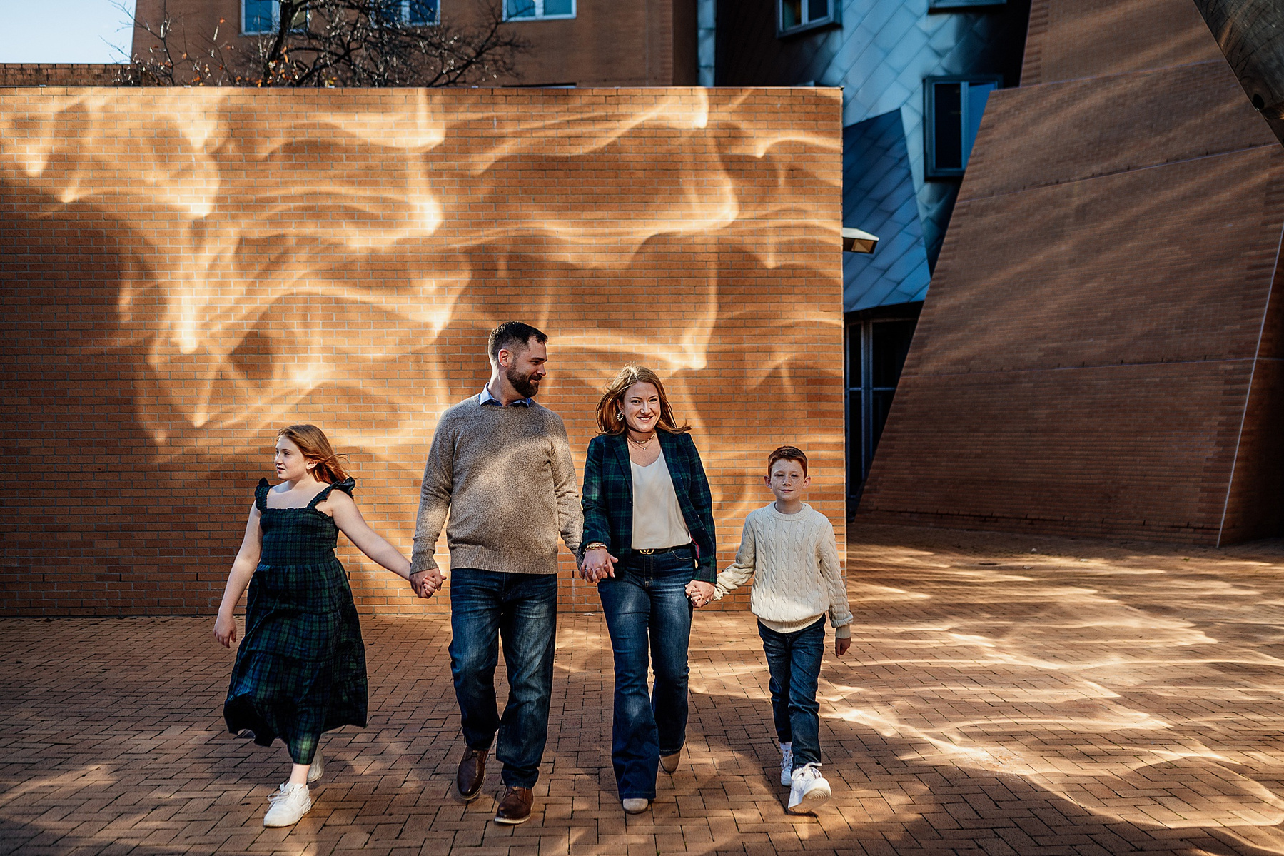 a family posing in front of a patterned wall on the MIT campus by boston family photographer korri leigh photography