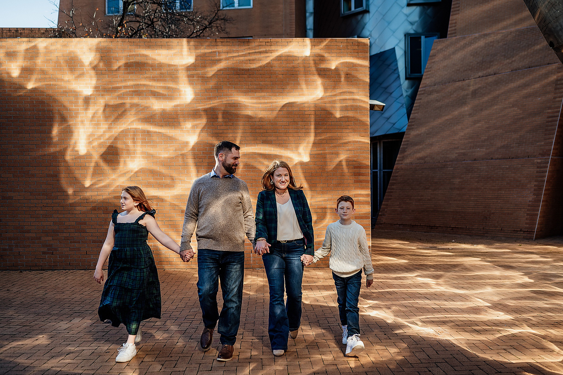 a family posing in front of a patterned wall on the MIT campus by boston family photographer korri leigh photography