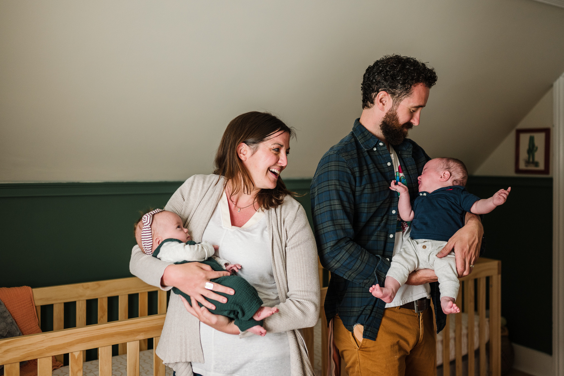 A mother and father each hold a newborn twin in Boston