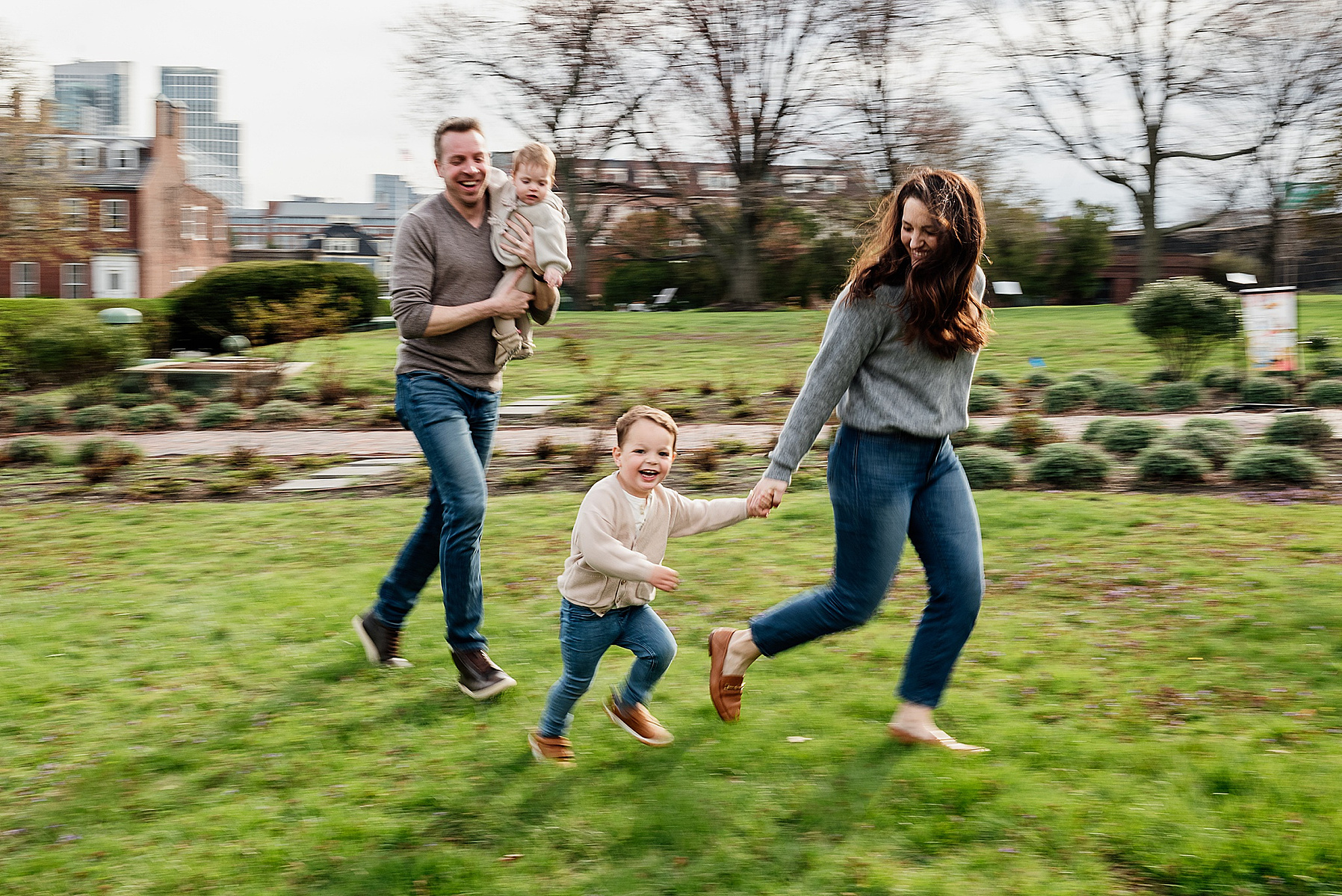 A family of 4 runs during their boston family photography session captured by west roxbury family photographer korri leigh crowley