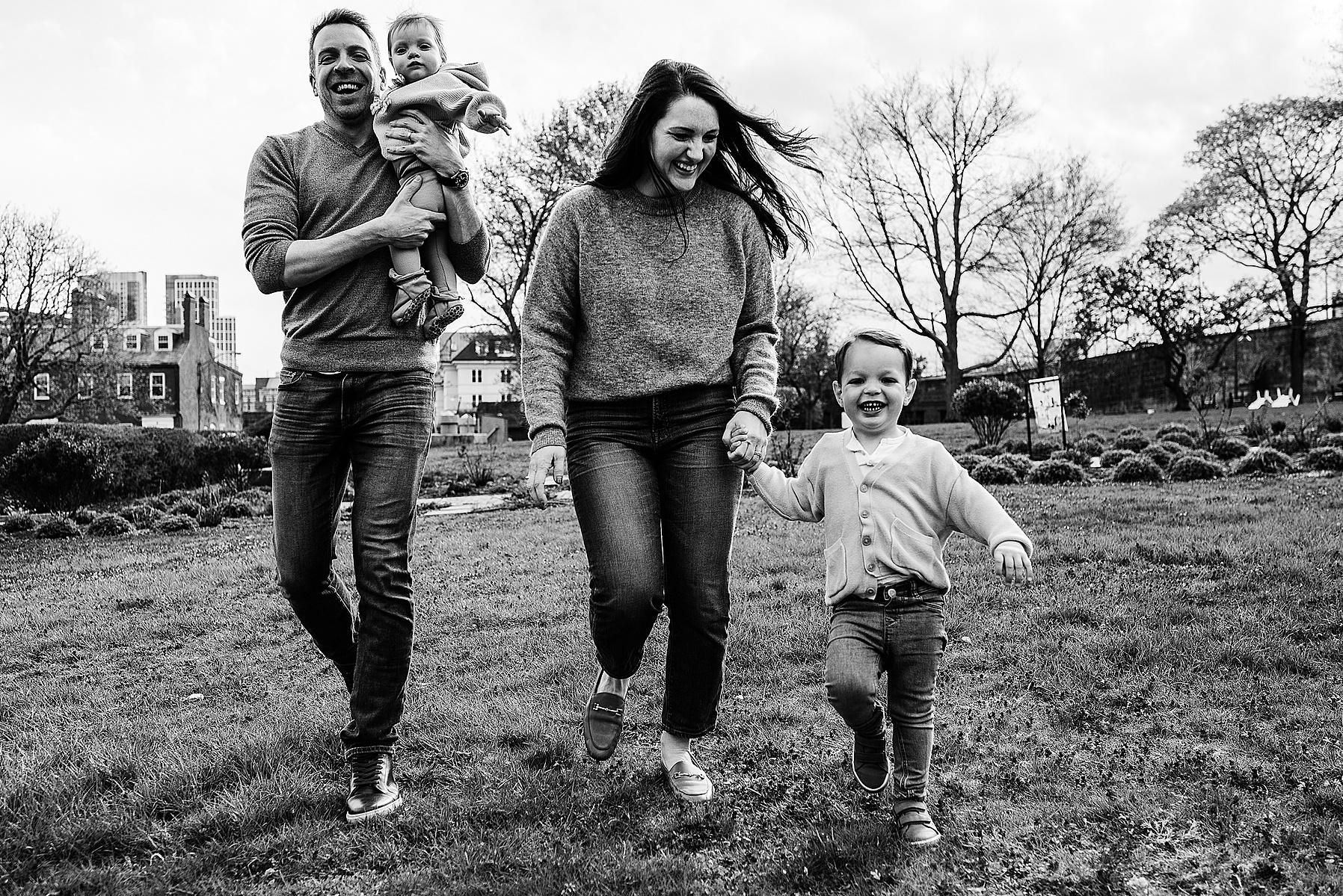 A family runs during their boston family photography session captured by west roxbury family photographer korri leigh crowley